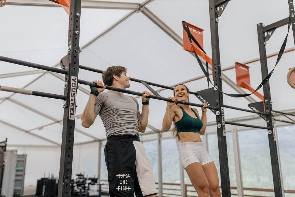 Home 20 Man and Woman Doing Pull Ups at the Gym